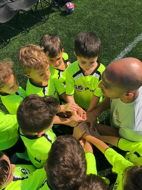 coach ernest and sb4u team meeting during their youth soccer game